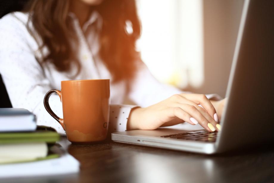 Blogger typing on laptop