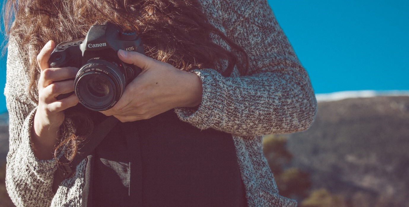 How to take good photos – close up of woman holding camera