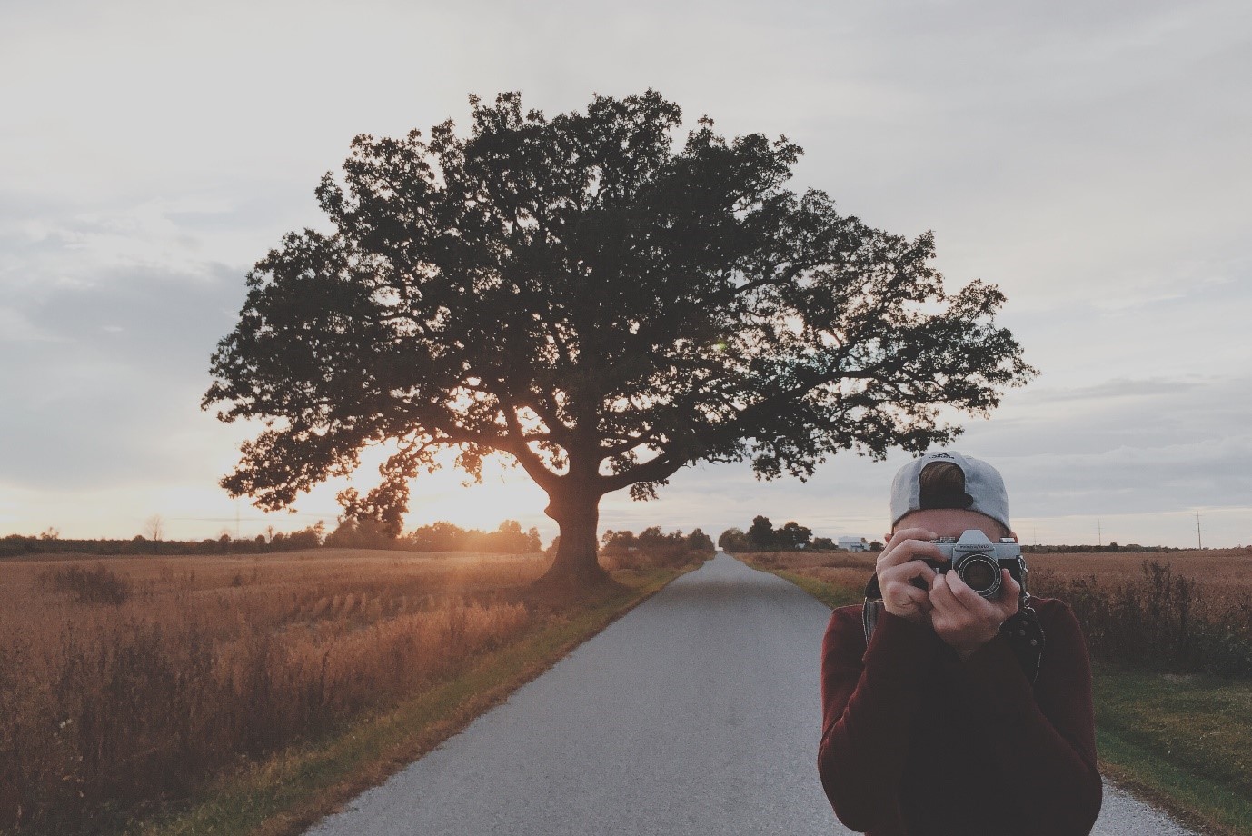 How to take good photos – man takes photo as sun sets