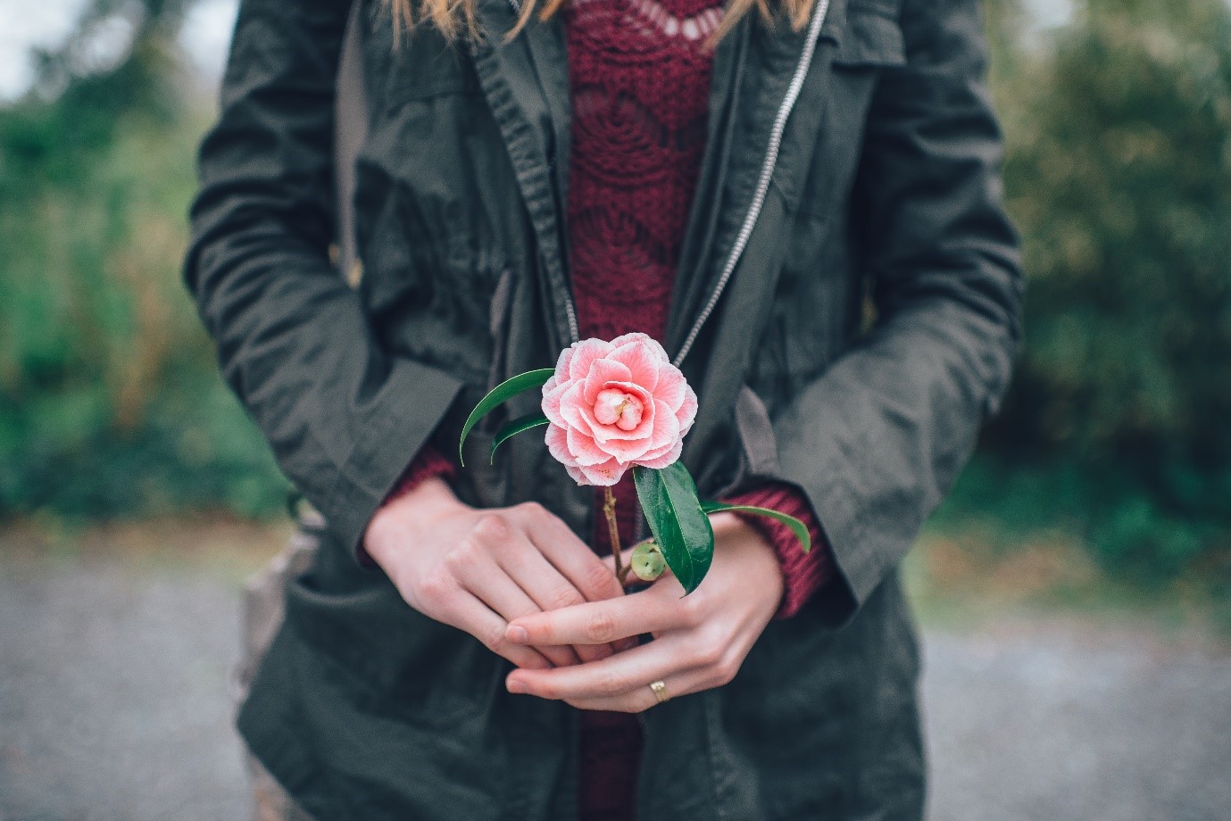 How to take good photos – woman holding flower as prop